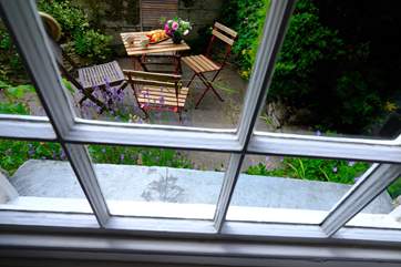 The secluded patio is a lovely place to sit at anytime of day.