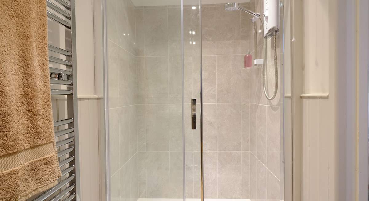 The shower-room has a super-sized shower.