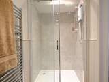 The shower-room has a super-sized shower.
