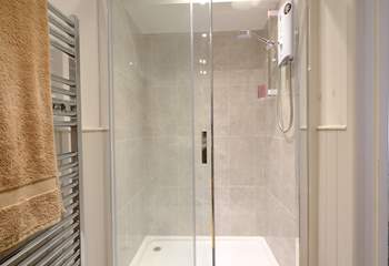 The shower-room has a super-sized shower.
