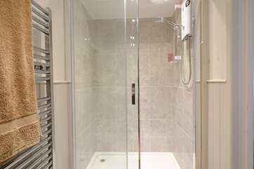 The shower-room has a super-sized shower.