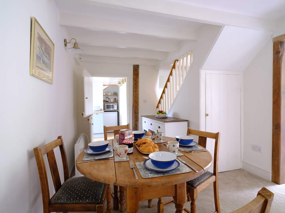The stairs to the first floor lead off the dining area.
