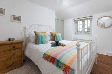 With reclaimed wooden floors and its feature window, Bedroom One is the perfect place to relax.