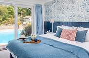 This beautiful bedroom looks out over the pool, open the door, step down and then jump straight in the pool (bedroom 2). How cool?
