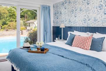 This beautiful bedroom looks out over the pool, open the door and step down and then jump straight in the pool (bedroom 2).