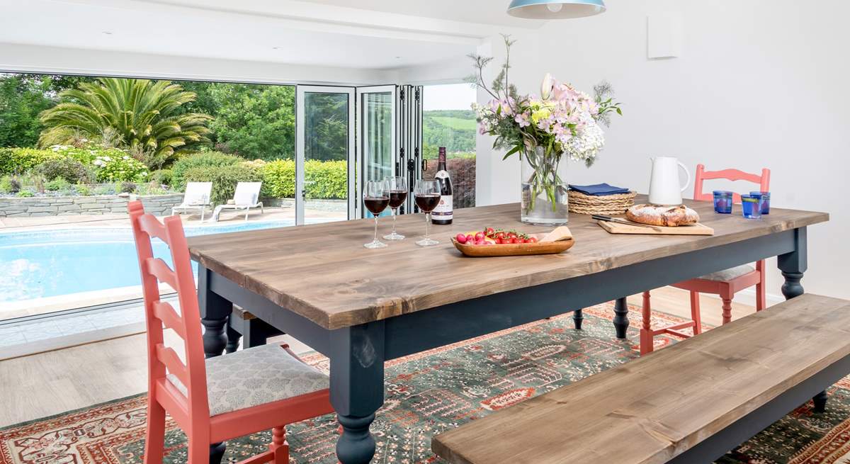 The dining-room is accessed through the kitchen and up three steps which gives you a lovely elevated view over the pool and through the picture window (please watch your head on the low ceiling as you descend the stairs).  