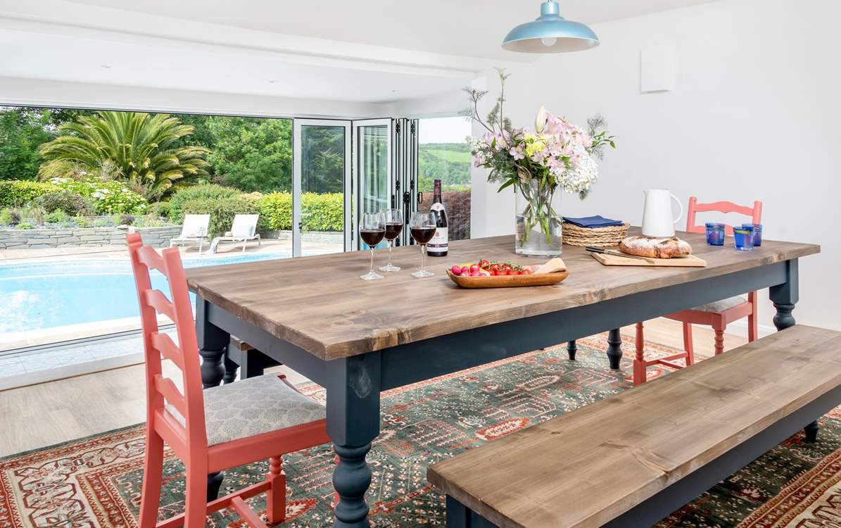 The dining-room is accessed through the kitchen and up three steps which gives you a lovely elevated view over the pool and through the picture window (please watch your head on the low ceiling as you descend the stairs).  