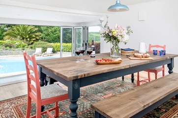 The dining-room is accessed through the kitchen and up three steps which gives you a lovely elevated view over the pool and through the picture window (please watch your head on the low ceiling as you descend the stairs).