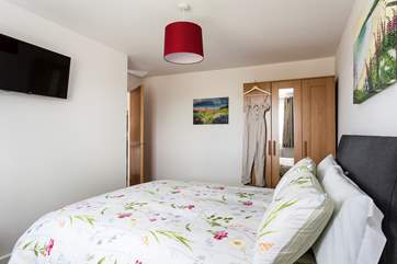 Bedroom 2 has a king-size bed and storage space.