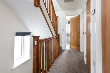 The first floor leading to the main bathroom and three bedrooms.