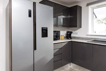 Coffee machine at the ready and a large fridge/freezer waiting to be filled.
