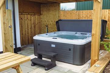 The newly installed hot tub, perfect for relaxing in after a day exploring the area.