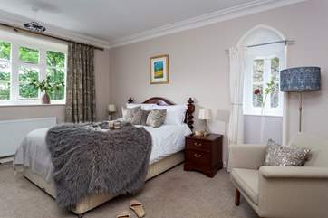 The main bedroom on the first floor with a king-size bed.