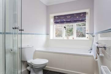The en suite bathroom for the main bedroom with a bath...