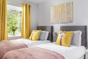 The twin bedroom is beautifully furnished.