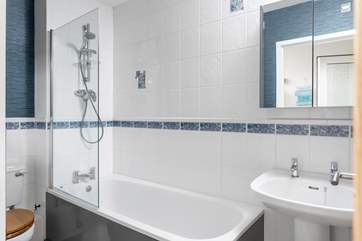 The family bathroom with an overhead shower in the bath.
