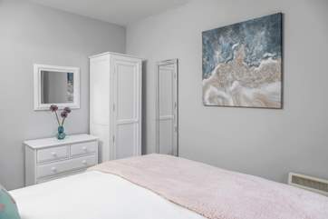 Bedroom 2 has a king-size bed and storage.