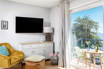 The stylish open plan living-room has magical views overlooking Swanpool Beach.