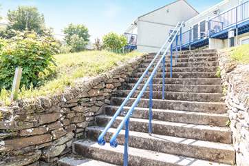 Steps lead up from the car parking area to the property.