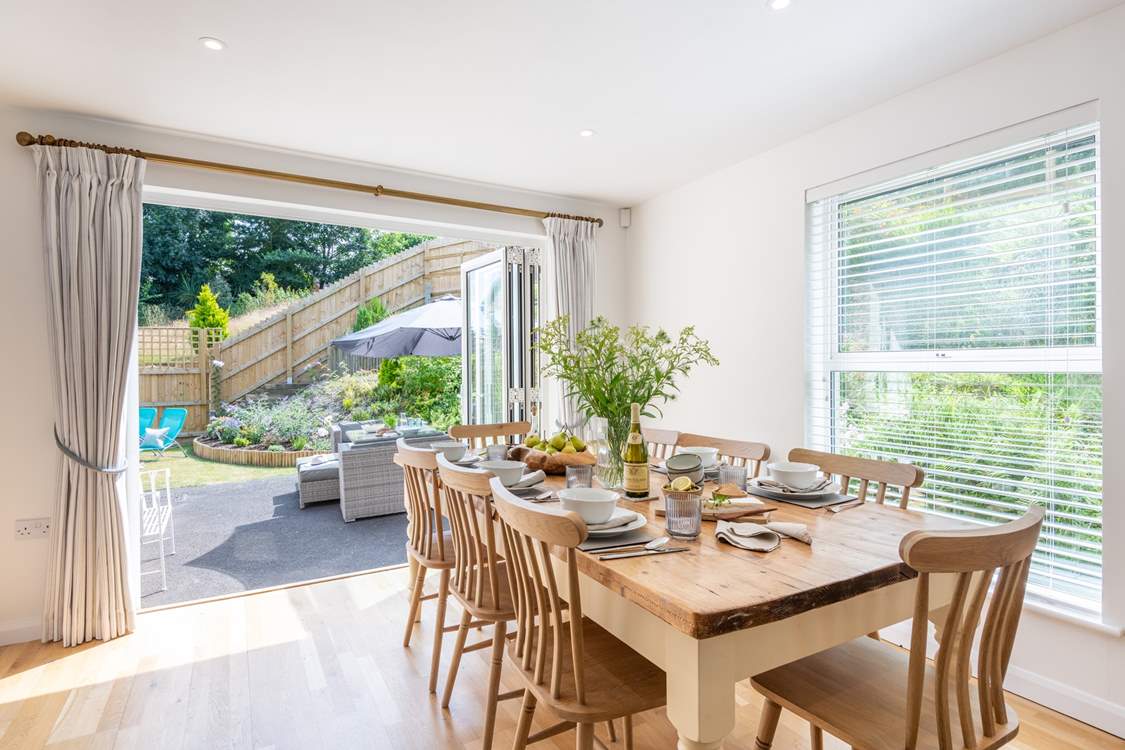 Open up the bi-fold doors in the kitchen/dining-room on to the garden.