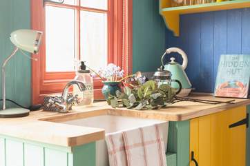 The colourful kitchen area has everything you need.