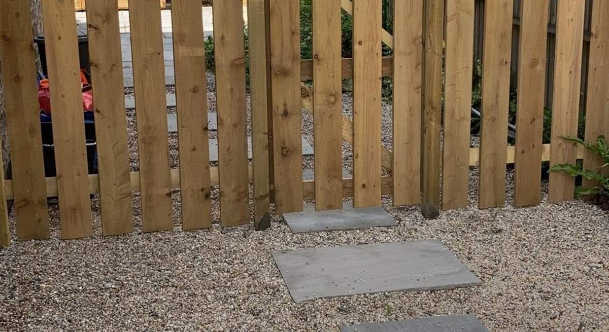 There is a fence and gate on the back patio. 