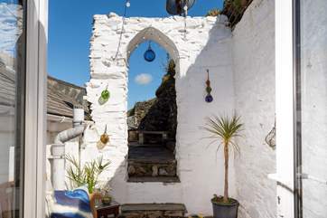 The little courtyard area has a Grecian feel, with two little seating areas.