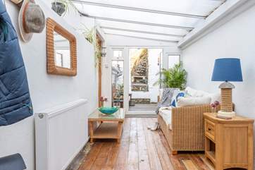 The entrance hall doubles up as a lovely sun-room, leading out to the courtyard.