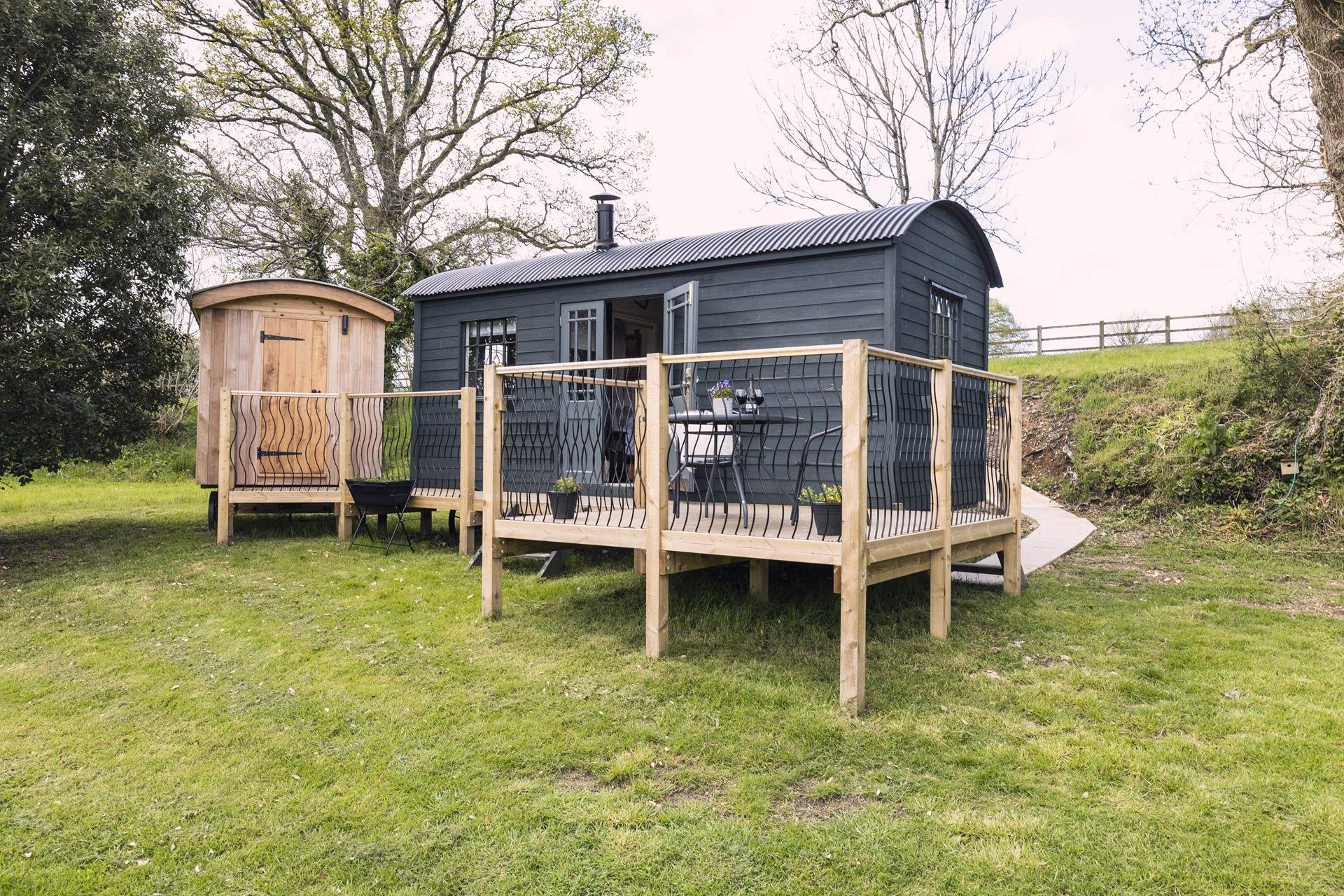 The deck links the hut and the shower room.