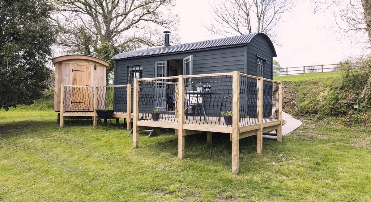 The deck links the hut and the shower room.