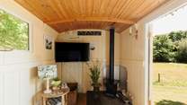 In here, you'll find another wood burner and a smart TV. 
