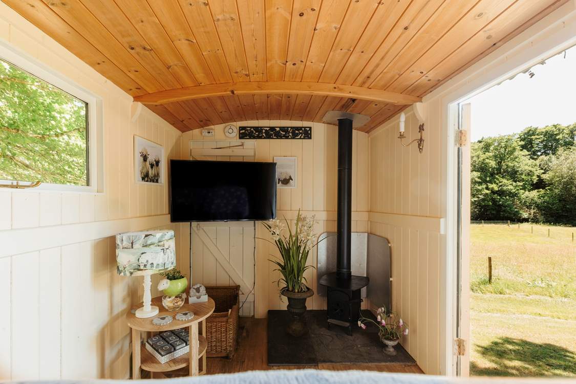 In here, you'll find another wood burner and a smart TV.