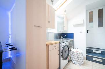 The utility area/games area is situated on the ground floor leading down from the kitchen.