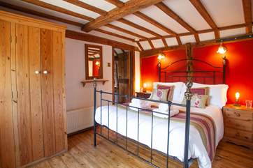 The beautiful ground floor bedroom is so warm and inviting.