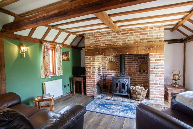 The living-room is so cosy with its inglenook fireplace and wood-burning stove.