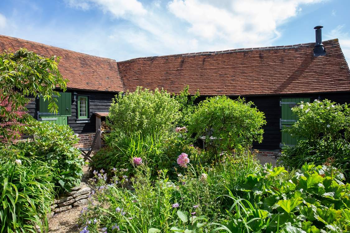 The cottage with the green door on the right is The Byre.