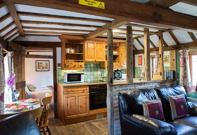 The open plan living area is cosy with lots of gorgeous beams, some low so please mind your head.