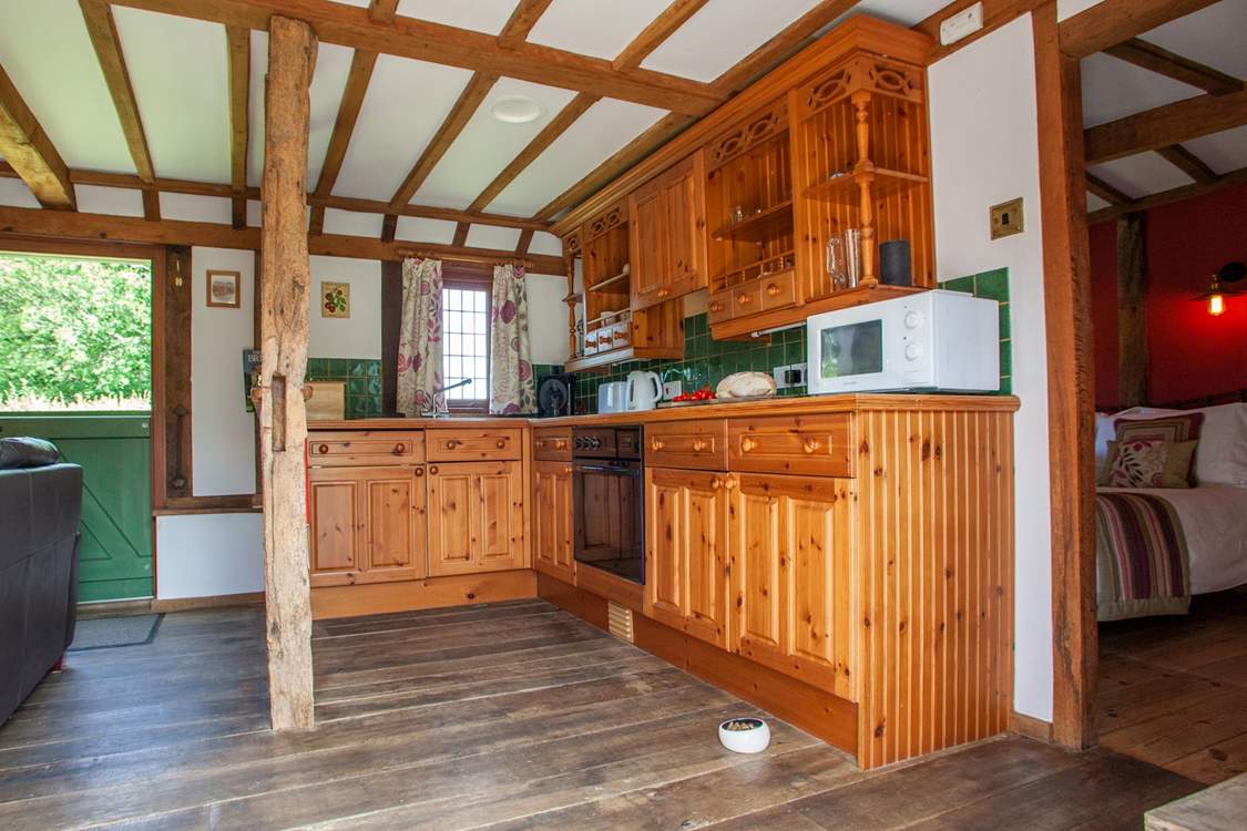 The fully equipped kitchen area. The door on the right leads to the bedroom and the stable-door takes you to an enclosed private garden ideal for those with dogs.