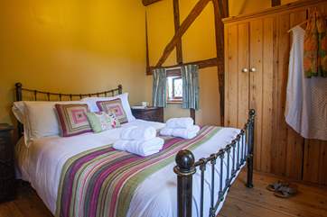 The ground floor bedroom is full of character with high sloping ceilings and gorgeous linens.