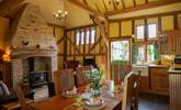 The open plan living/dining-room with a full kitchen area and stone floors throughout. - Thumbnail Image