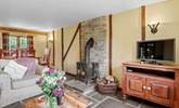 The open plan living-room with gorgeous stone floors and wood-burner. - Thumbnail Image