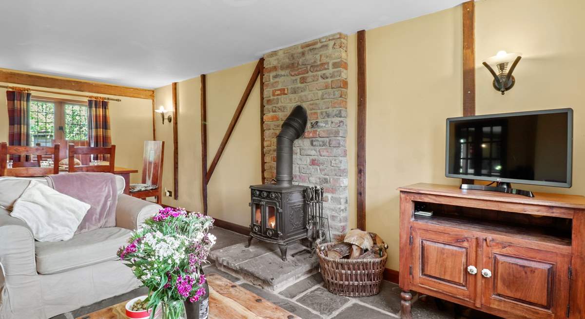 The open plan living-room with gorgeous stone floors and wood-burner.