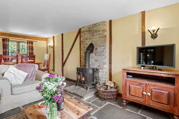 The open plan living-room with gorgeous stone floors and wood-burner.