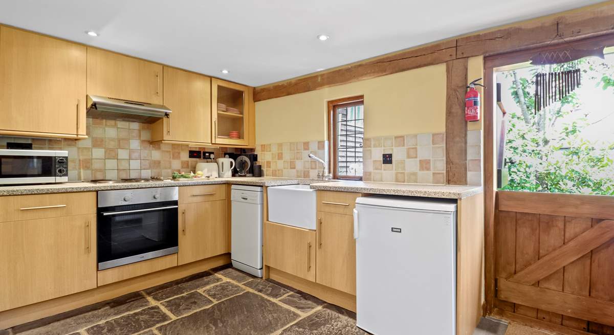 The kitchen with lovely Butler sink and stable-door is complete with a dishwasher, microwave and a Dolce Gusto coffee machine.