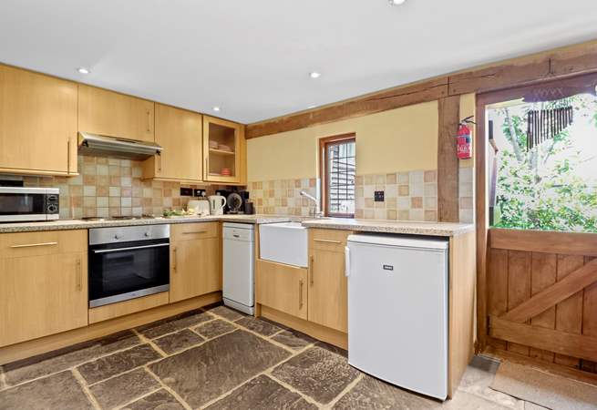 The kitchen with lovely Butler sink and stable-door is complete with a dishwasher, microwave and a Dolce Gusto coffee machine.