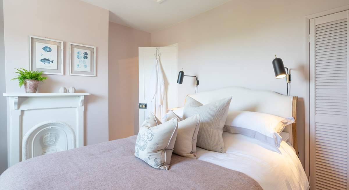 The stylish main bedroom on the first floor has wonderful sea views.