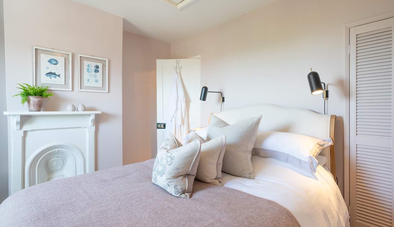 The stylish main bedroom on the first floor has wonderful sea views.