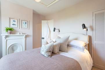 The stylish main bedroom on the first floor has wonderful sea views.