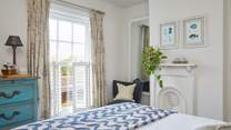 The stylish main bedroom on the first floor has wonderful sea views.