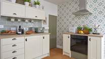 The kitchen/dining-room is modern and well-equipped for you to cook up a treat! 